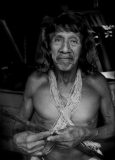 Davo Enemenga, a Huaorani man whose ancestral land has been contaminated by oil exploration by Chinese government-owned, Petro Oriental. "They promised to help us (the local Huaorani residents) and and did not, says Enomenga. They caused us problems. They paid us nothing, no cash (his word, "silver" coins or cash). They cheated us". Proveta, south of Coca, Ecuador. Still, Davo has not lost sight of his traditions. His spear, clothing and twine all come from materials only found in the distant, more pristine rainforest. According to the company website, "PetroOriental S.A. are companies established through capital provided by state-run firms from the People's Republic of China. These include: China National Petroleum Corporation (CNPC) with 55% shareholder participation and China Petrochemical Corporation (SINOPEC) with 45% shareholder participation."