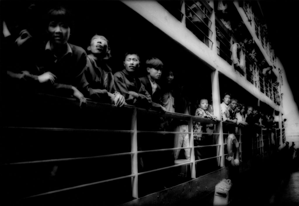 Peasants crowding the rails of a river steamer. Three Gorges, Yangtze River, China. 1997